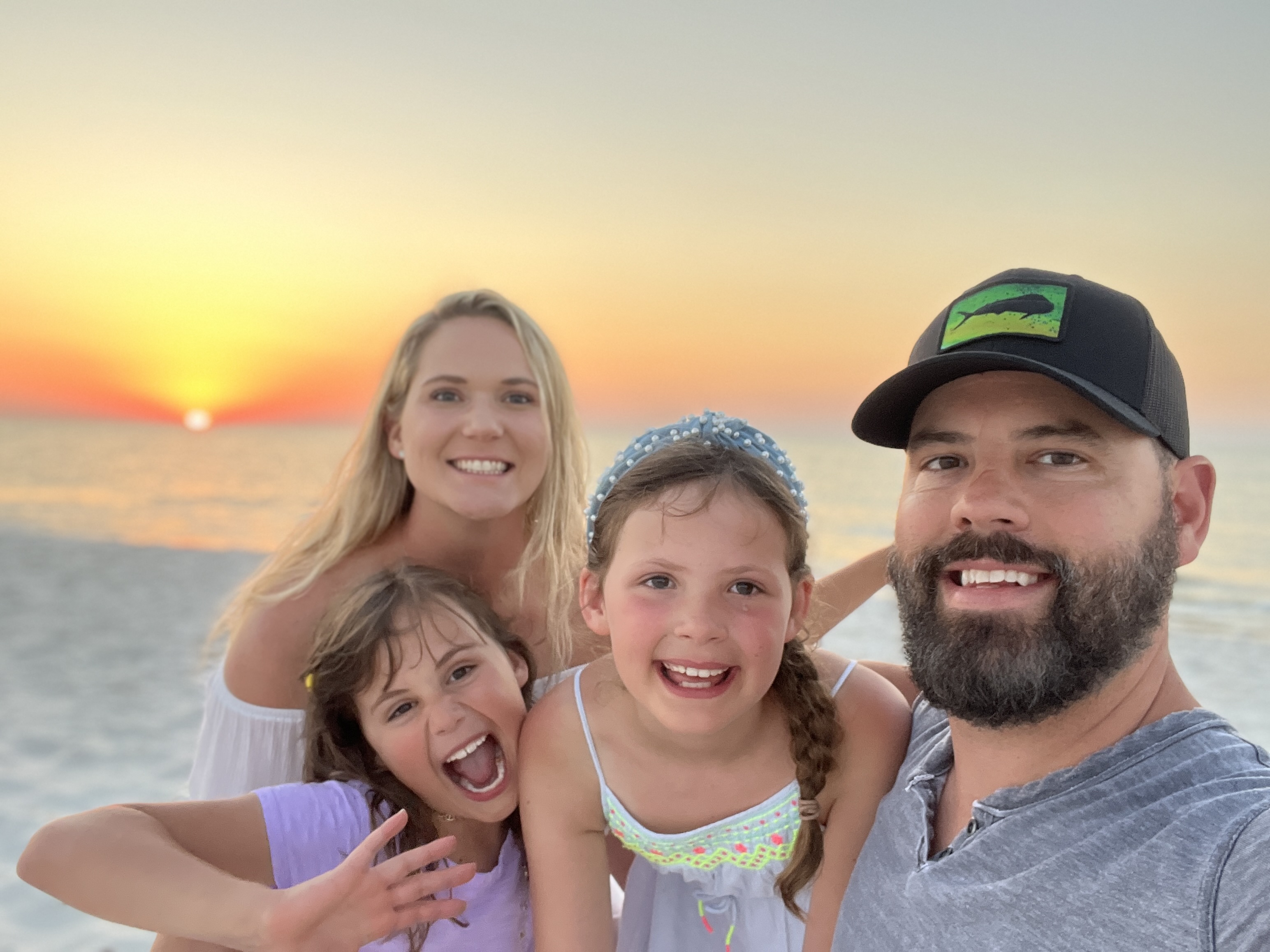 Family enjoying a sunset on the beach at Sunny Times Beach House in Cape San Blas, Florida