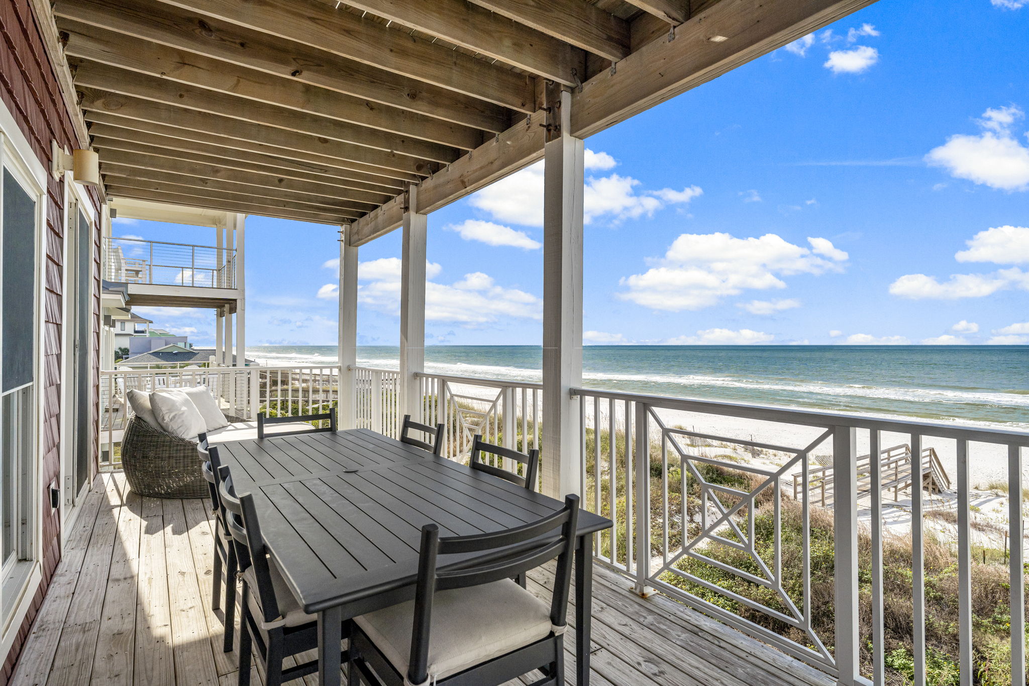 Outdoor deck with dining area and Gulf views at Sunny Times Beach House Cape San Blas